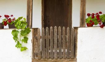 old wooden gate to the white village house. Selective focus photo