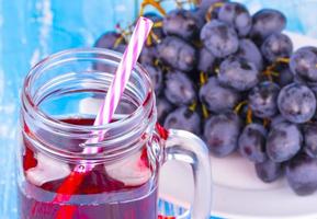 grape juice or smoothie on an old blue wooden table photo