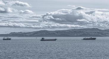 blurred view of Fishing seiners and cargo ships in Avacha Bay in Kamchatka peninsula photo