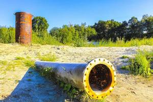 Huge drain pipe at quarry pond in Germany. photo