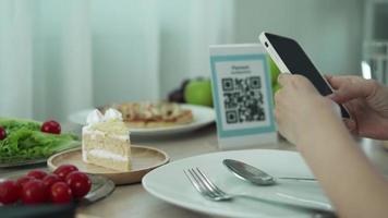 Woman use smartphone to scan QR code to pay in cafe restaurant with a digital payment without cash. Choose menu and order accumulate discount. E wallet, technology, pay online, credit card, bank app video