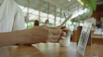 woman use smartphone to scan QR code in cafe. The restaurant built a digital payment system without cash. Qr code pay, E wallet, cash technology, pay online video