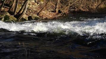 Fast river with waves, foams and splashes in slow motion video