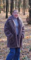 Girl in a warm coat in an autumn park with yellow foliage video