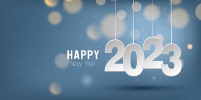 Happy New Year 2023. Hanging paper cut number and bokeh bubber on blue gradient background.