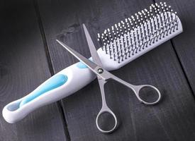 Hairdressing Scissors and massage comb. Close up photo