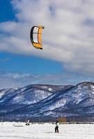 festival de deportes de invierno nevado en kamchatka. competiciones de kitesurf de invierno. foto