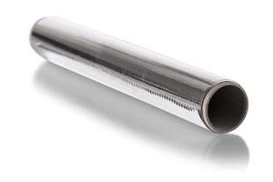 A Silver aluminium foil roll isolated on the white background. The foil is extremely pliable and can be bent or wrapped around objects with ease. photo