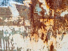 Rusty metal grunge abstract background. Rusted steel tin abstract pattern with torn paper posters. photo