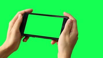 Hand holding smartphone green screen, green screen, smart phone with green screen video