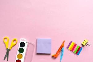 Back to school background. School accessories on a pink background. photo