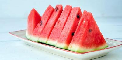 Tasty sliced fresh watermelon They are arranged beautifully in a plate. photo