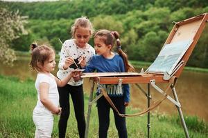 Little girls painting outdoors photo
