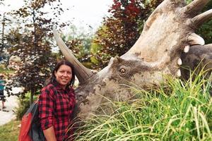 Woman with dinosaur replica photo