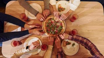 People eating pizza top view photo