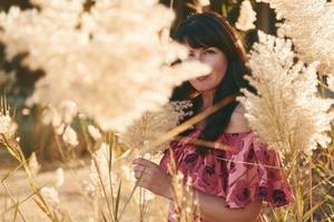 Woman posing by a garden photo