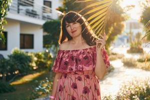 Woman posing by a garden photo