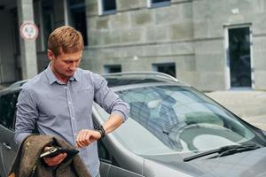 Businessman by the car photo