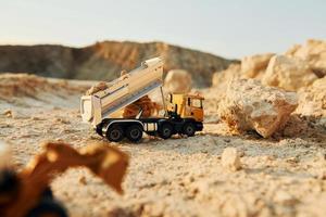 Loading vehicle miniatures outdoors on the borrow pit at daytime photo