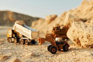 Loading vehicle miniatures outdoors on the borrow pit at daytime photo