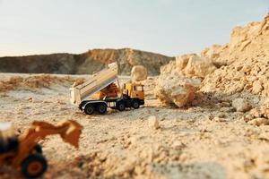 Loading vehicle miniatures outdoors on the borrow pit at daytime photo