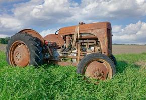 abandoned old and rusty Tractor on Field,North Frisia,Germany photo