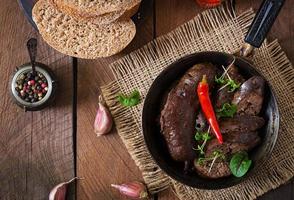 Homemade blood sausage with offal on the old wooden background in rustic style. Top view photo