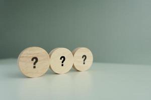 Question mark symbol on wooden circle with copy space. Ask, FAQ, Advice, Support, Problem and solution concept. photo