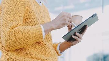 volwassen zakenman gebruik makend van een digitaal tablet naar bespreken informatie met een jonger collega in een modern bedrijf lounge video