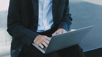 Mature businessman using a digital tablet to discuss information with a younger colleague in a modern business lounge video