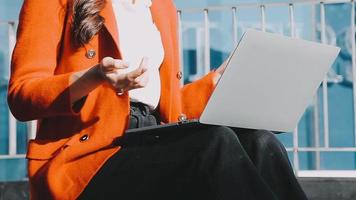 Mature businessman using a digital tablet to discuss information with a younger colleague in a modern business lounge video