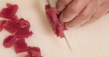 Japanese Chef Cutting Tuna Meat Using Knife On A White Chopping Board. - high angle shot video