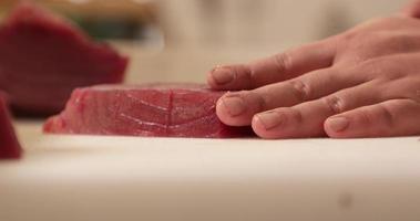 Hands Cutting Fresh Tuna Meat Using A Knife. - Close Up Shot video