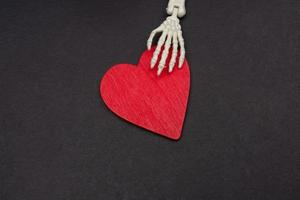 Artificial human body skeleton hand with a heart icon