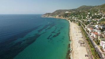 Kleopatra Beach in Alanya, Turkey. Drone view coast line long beach. Summer, sun, palms, sand, sea and Alanya Castle. video