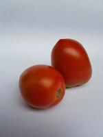 red tomatoes on white paper photo