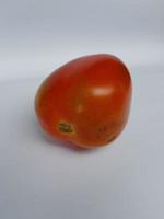 red tomato on white paper photo