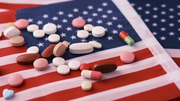 White Color Medical Pills Spilling On American Flag video