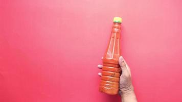 Holding Tomato Sauce In A Bottle On Red Background video