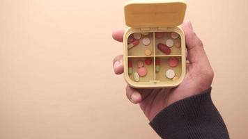 Top View Of Medical Pills In A Pill Box On Color Background video