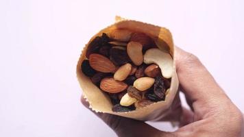 Close Up Of Many Mixed Nuts Spilling From A Paper Bag video