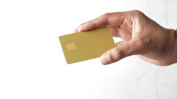 Person Hand Holding Credit Card Against A White Wall video