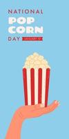 Vertical banner for National Popcorn Day on January 19th. Hand holding box of red and white striped popcorn. vector