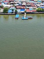 Top view of Tourist boats is docking on the banks at the piers on Chao Phraya River, Bangkok Thailand photo