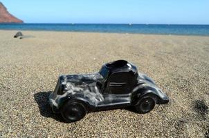 Toy car on the beach photo