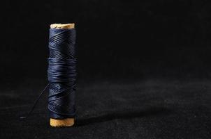 Isolated spool of sewing thread photo