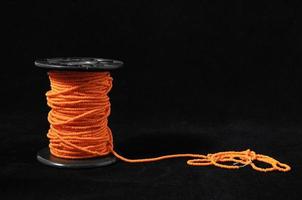 Isolated spool of sewing thread photo