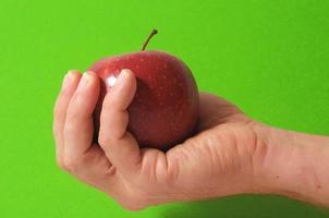 Hand holding apple photo