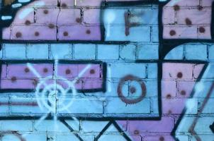 Fragment of graffiti drawings. The old wall decorated with paint stains in the style of street art culture. Colored background texture in cold tones photo