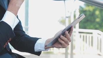 Businessman using tablet analyzing sales data and economic growth graph chart. Business strategy. Abstract icon. Digital marketing. video